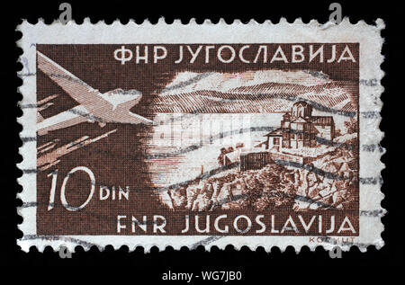 Stamp issued in Yugoslavia shows Lake Ohrid with Saint John Monastery, Airplanes and Landscapes series, circa 1951. Stock Photo