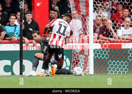 London, UK. 31st Aug, 2019. Ollie Watkins of Brentford beats Derby County Goalkeeper Kelle Roos to the ball during the EFL Sky Bet Championship match between Brentford and Derby County at Griffin Park, London, England on 31 August 2019. Photo by Ken Sparks. Editorial use only, license required for commercial use. No use in betting, games or a single club/league/player publications. Credit: UK Sports Pics Ltd/Alamy Live News Stock Photo