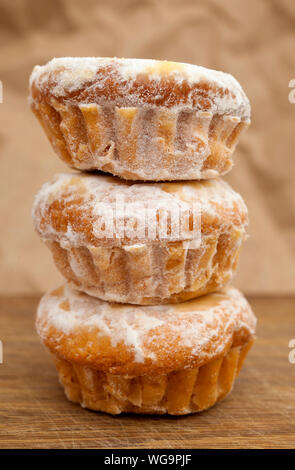 Portuguese sweet queijadastacked on wooden surface Stock Photo