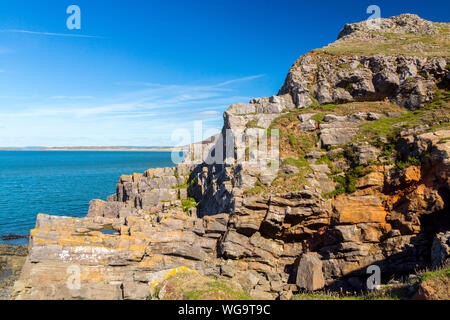 The carboniferous limestone outcrops and clifffs at Worms Head on the Gower peninsula, South Wales, UK Stock Photo