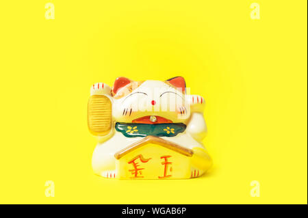 Maneki Neko Japanese lucky cat figure Stock Photo