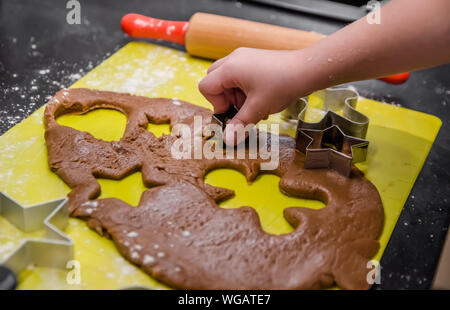 Little girl makes Christmas ginger cookies Stock Photo