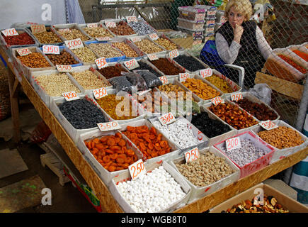 Cholpon Ata, Kyrgyzstan - August 20, 2019: Dried fruits and nuts on display on a market in Cholpon Ata, Kyrgyzstan. Stock Photo