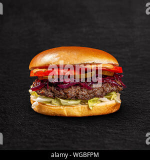 Fresh tasty burger on black background Stock Photo