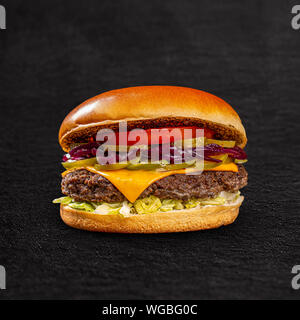 Homemade juicy burger with beef, cheese and caramelized onions Stock Photo