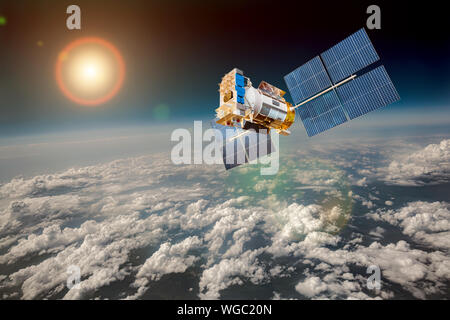 Space satellite orbiting the earth. Elements of this image furnished by NASA. Stock Photo