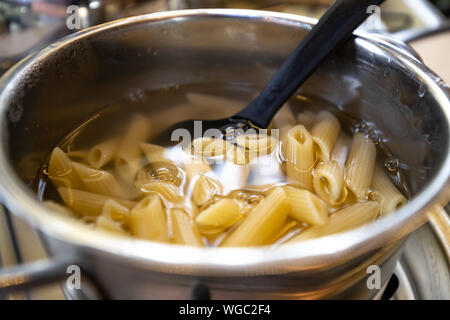 Cooking fresh pasta in a pot Stock Photo