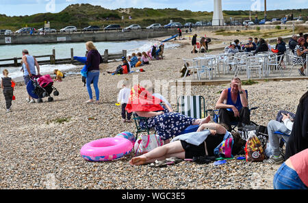 Littlehampton Sussex UK 1st September 2019 - Visitors enjoy the sunny weather on Littlehampton beach and seafront despite a stiff breeze . Credit : Simon Dack / Alamy Live News Stock Photo