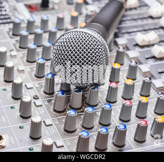 Microphone on sound mixing console. Close up shot Stock Photo