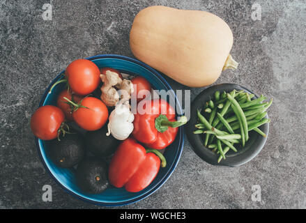directly above shot of healthy vegetables in bowls on stone kitchen counter Stock Photo