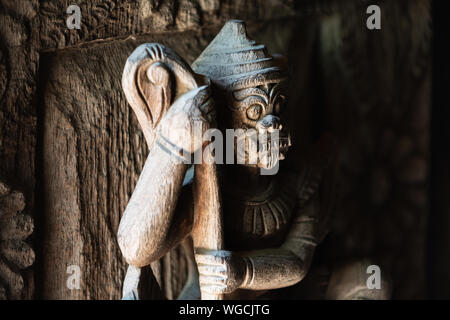 Wooden Ramayana guardian statue on the gates of teak Shwe In Bin Kyaung monastery in Mandalay, Myanmar Stock Photo
