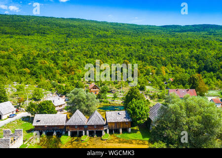 Croatia, region of Lika, Majerovo vrilo river source of Gacka, traditional village, old wooden mills and cottages aerial drone view Stock Photo