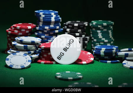 Close up shot of group poker chips on green table. Stock Photo