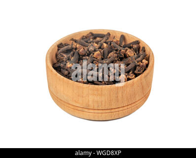 Dry cloves in wooden bowl isolated on white background Stock Photo