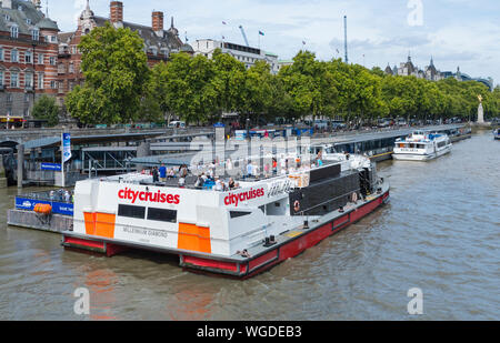 City Cruises sightseeing boat for sightseers seeing London by boat from the River Thames at Westminster Pier, Westminster, London, England, UK. Stock Photo