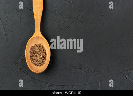 Large spoon with dry cumin close-up on concrete background Stock Photo