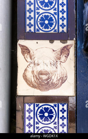 Tiles featuring a pig's head on old Victorian butcher's premises in King's Lynn, Norfolk. Stock Photo