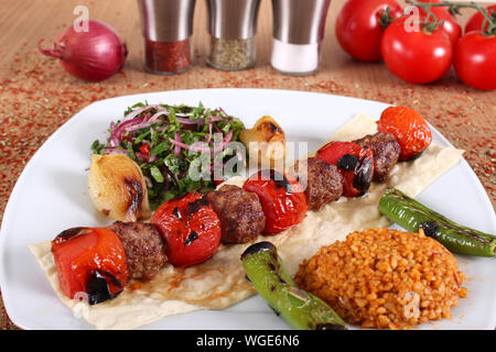 Meat and tomato kebabs with fresh and vegetables Stock Photo
