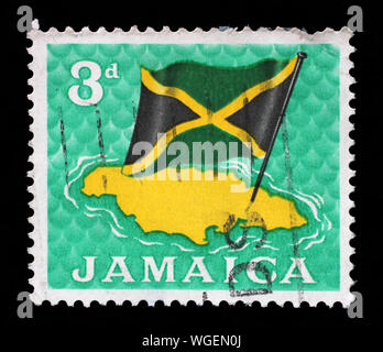 Stamp printed in Jamaica shows National Flag over Jamaica, circa 1964. Stock Photo