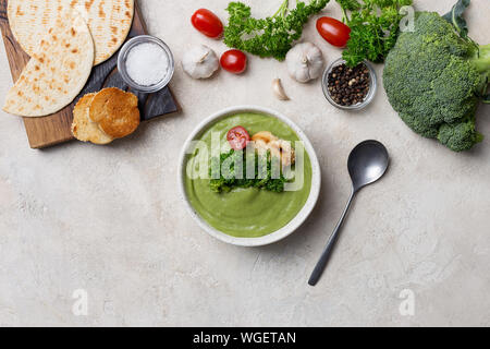 Cream soup with vegetables on bright background. Broccoli soup with crouton. Concept of healthy seasoning food Stock Photo
