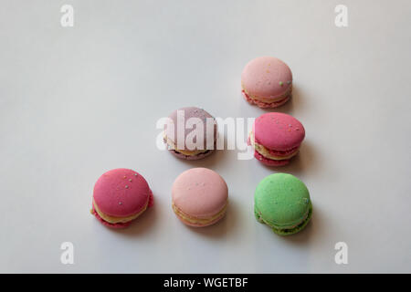 Colorful macaroon cakes triangle shaped composition isolated on white background Stock Photo