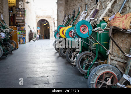 Doha, Qatar - 25 Nov 2016: Row of wheelbarrows waiting for their porter in the early afternoon. Taken in Souq Wakif, Doha Stock Photo