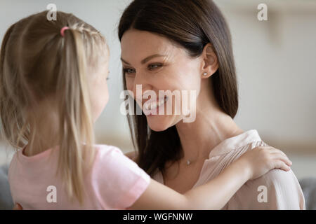 Close up image daughter embraces loving mother Stock Photo