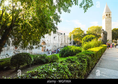 Tourists gather at the Statue of Gregory Nin outside the ancient Golden Gate to the Diocletian's Palace section of Old Town Split, Croatia. Stock Photo