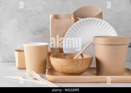 Eco friendly dishes. Disposable paper cups, dishes, fast food containers, wooden bowl and bamboo cutlery. recycling concept Stock Photo