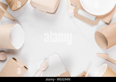 Frame made of eco friendly disposable tableware. Paper cups, dishes, fast food containers and bamboo wooden cutlery. flat lay. recycling concept Stock Photo