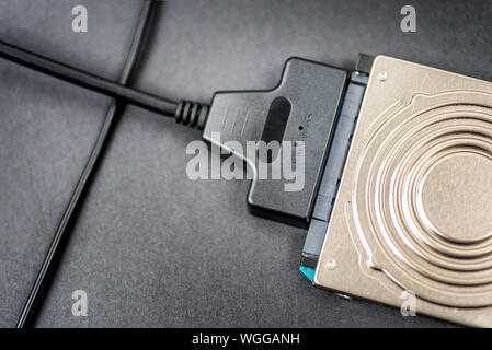 sata cable connected to hdd 2.5 hard drive disk closeup view Stock Photo