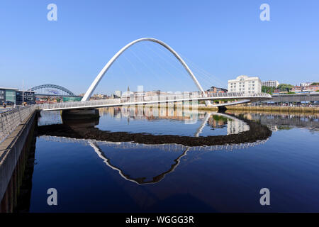 Under a blue sky Newcastle upon Tyne and Millennium Bridge viewed from Gateshead side of river Tyne