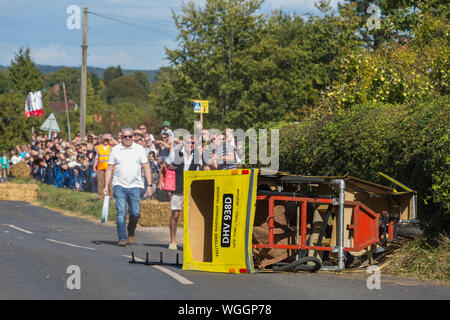 Cookham Dean, UK. 1 September, 2019. A custom-built kart in the form of Trotter's Independent Trading Reliant Regal van from the TV series 'Only Fools and Horses' crashes during the Cookham Dean Gravity Grand Prix in aid of the Thames Valley and Chiltern Air Ambulance. Credit: Mark Kerrison/Alamy Live News Stock Photo