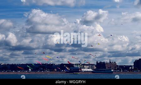 Multi Colored Kites Over Sea Against Sky