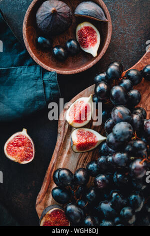 Top view of Autumn food flat lay with season fruits like Bangalore blue grape and figs on a table. Stock Photo