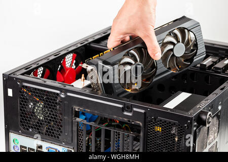 hand plugging a video card while maintenance personal computer hardware Stock Photo