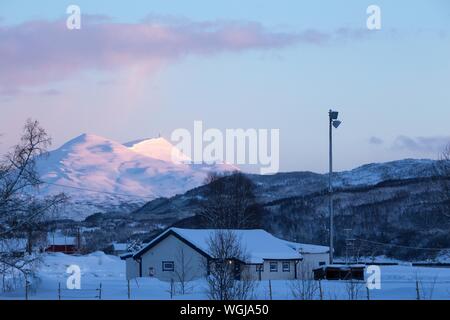 traditional norwegian wooden house and mountains in the distance. Lofoten Islands. Norway. world travel Stock Photo