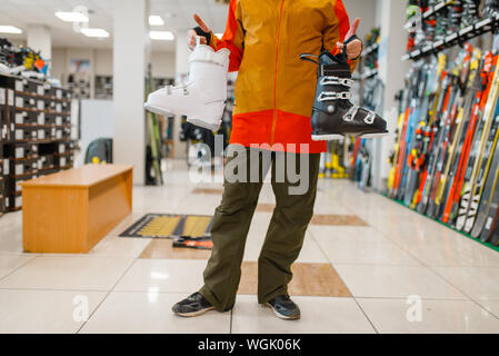 Male person with ski or snowboarding boots Stock Photo