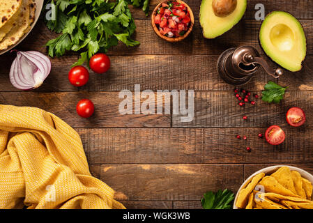 Food frame with vegetables and spices for cooking on a wooden background. Top view, copy space. Mexican spicy food concept Stock Photo