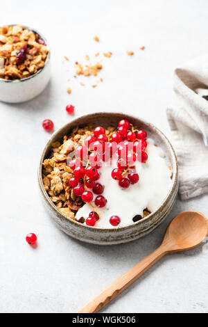 Yogurt with granola and berries in bowl. Healthy breakfast cereals with greek yogurt. Clean eating, dieting concept Stock Photo