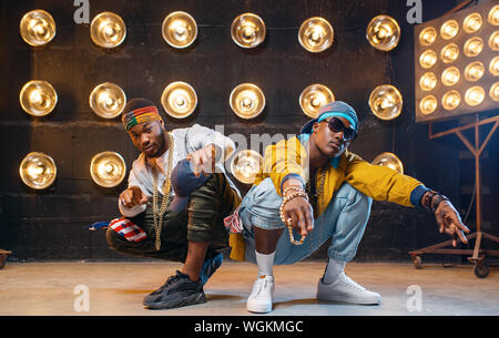 Two black rappers sitting on the floor Stock Photo