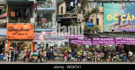 Street with flower stores and typical residential houses in Hanoi old town, Vietnam Stock Photo