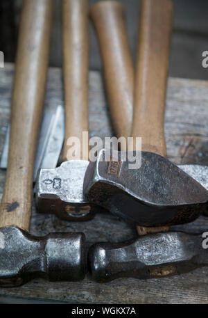 A blacksmith's hammers on a bench Stock Photo