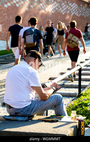 Artist painting en plein air on the street by Wawel Hill in Krakow, Poland Stock Photo