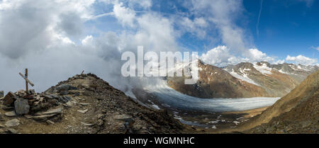 Mountain top view of Glacier Senales partly covered in clouds Stock Photo
