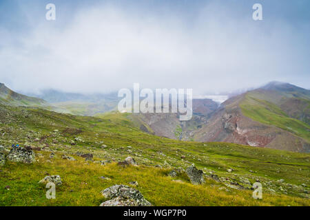 Kazbegi, Georgia - Mount Kazbegi landscape with dramatic clouds up in the trekking and hiking route. Stock Photo