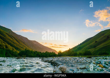 Svaneti landscape at sunset with mountains and river on the trekking and hiking route near Mestia village in Svaneti region, Georgia. Stock Photo