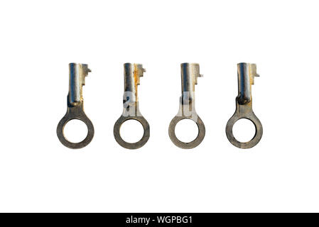 Four silver old padlock keys lying next to each other, isolated on a white background with a clipping path. Stock Photo