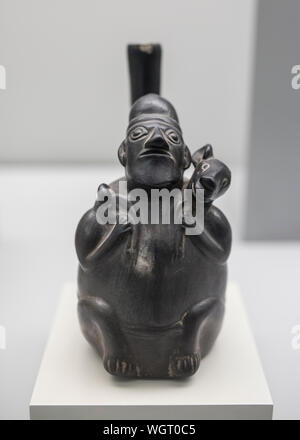 Madrid, Spain - Sept 8th, 2018: Chimu vessel depicting a man carriyng on back an animal, 1100 AC. Museum of the Americas, Madrid, Spain Stock Photo