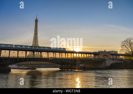 Paris France city skyline sunrise at Eiffel Tower and Seine River with Pont de Bir-Hakeim bridge and Paris Metro Stock Photo